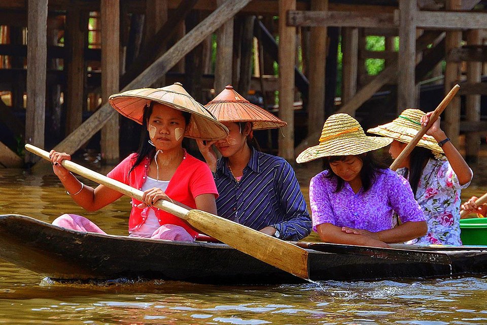women paddling a long boat
